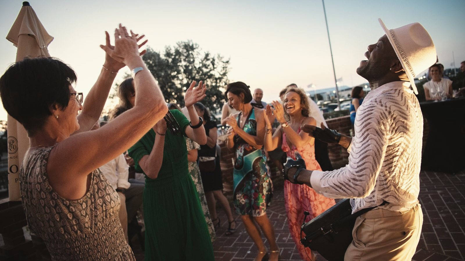 Invités dansant en terrasse au crépuscule